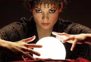 Woman gazing over glowing crystal ball