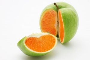 apple cut open showing an orange inside