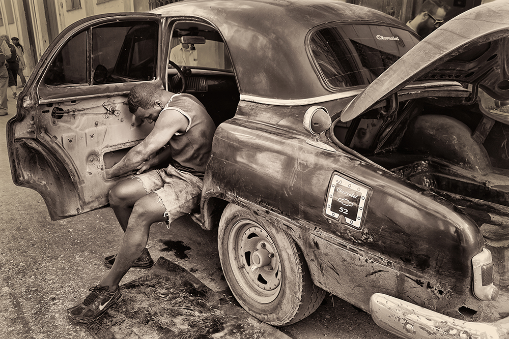 Cuban restoring dilapidated car